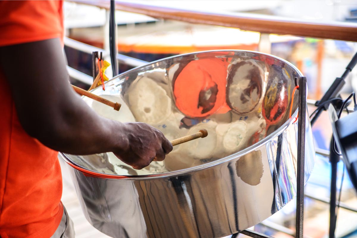 man is playing on a steel drums at cruise ship open deck